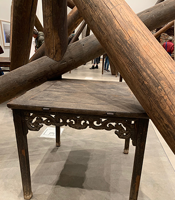 pillars and beams cross each other at crazy angles in the museum gallery