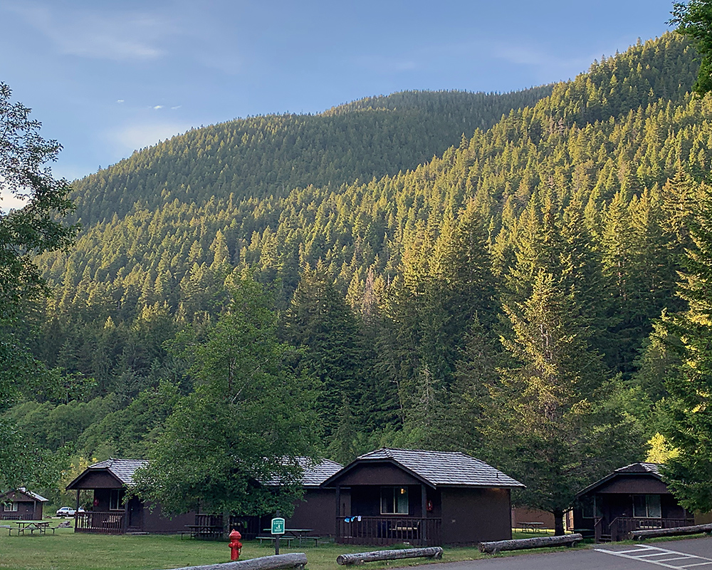 Cabins with hills of Sol Duc valley behind.