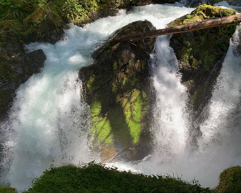 The Sol Duc River falls over a brink into a chasm