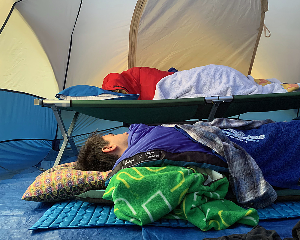 Morning view of my sons inside the tent; one is on cushions, the other on a cot.