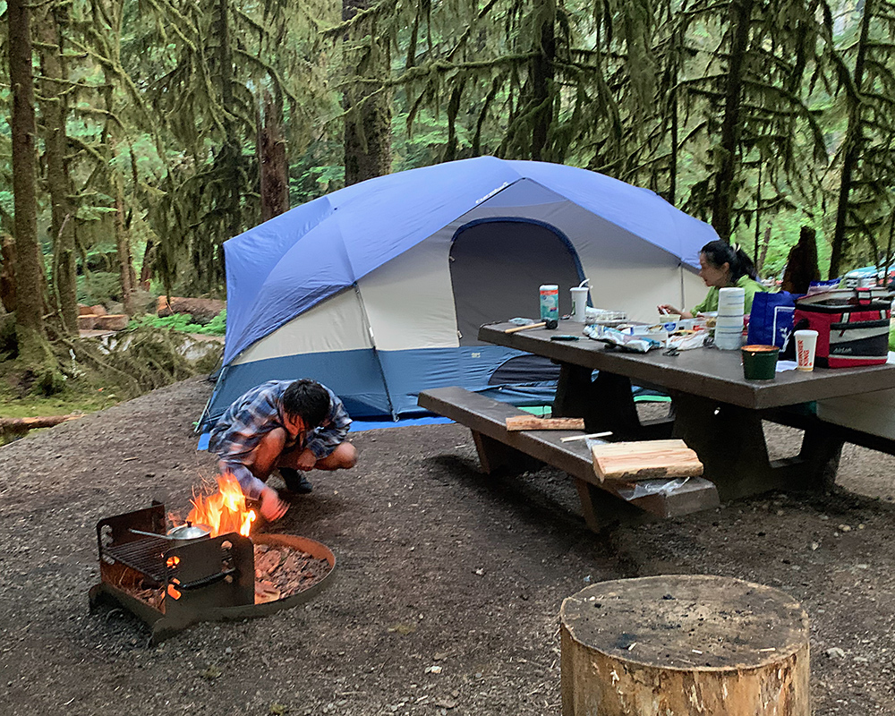 The tent is set up in the forest.