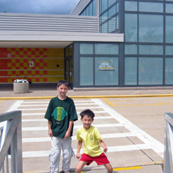 Two kids happy to be standing outside the Family Museum