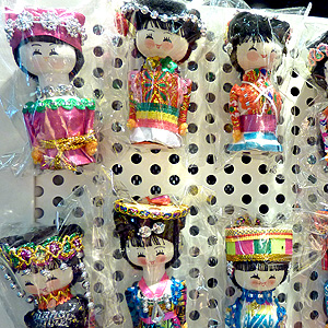 Magnets for sale in Hong Kong airport gift shop, each one wearing ethnic costumes of Chinese peoples