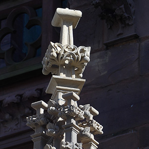 A stone statue showing a holy man with curly hair. 