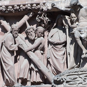 Mary sits and faces the viewer, holding both her hands up with palms facing us.  She is brown and so is her left hand, but her right hand is white