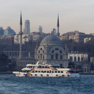 Another ferry with the city behind it.