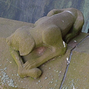 Jesus stands under an arch that proclaims he is the lamb of God
