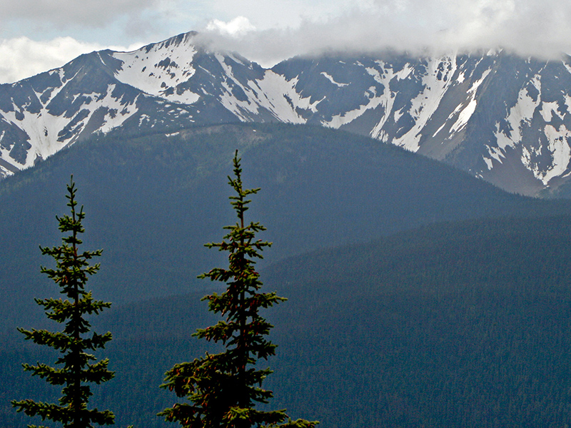 Frosty Mountain with snow rises beyond the hills