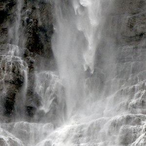 looking closely at the water falling over the cliff