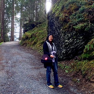 Jeri is standing by a tremendous rock