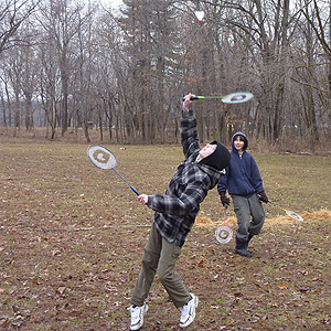 Badminton game with each player holding two raquets