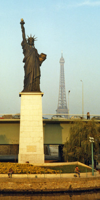 Eiffel Tower behind the Statue of Liberty