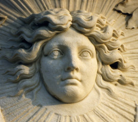the face of Louis XIV as the Sun King carved in marble