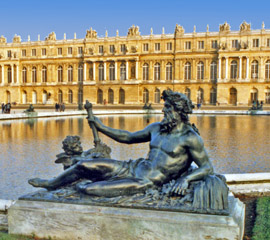 Reclining statue of a god in front of a pond at Versailles, photo by Virginia Ives